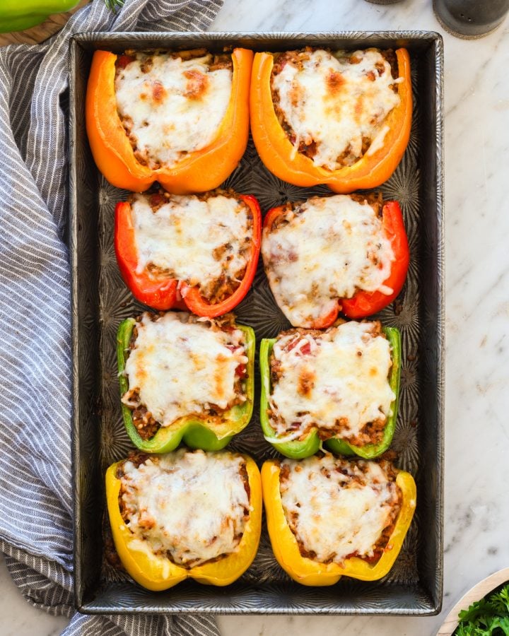 Overhead view of healthy Stuffed Peppers arranged on a baking sheet after baking