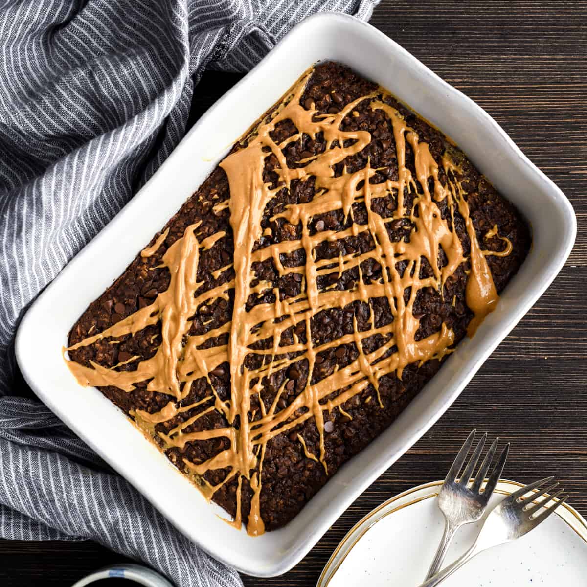 Overhead view of Healthy Chocolate Peanut Butter Baked Oatmeal with a peanut butter drizzle