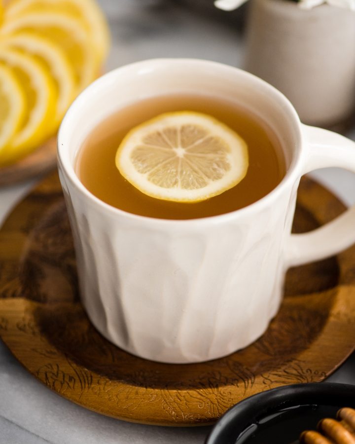 a mug of immune boosting tea with a slice of lemon floating in it