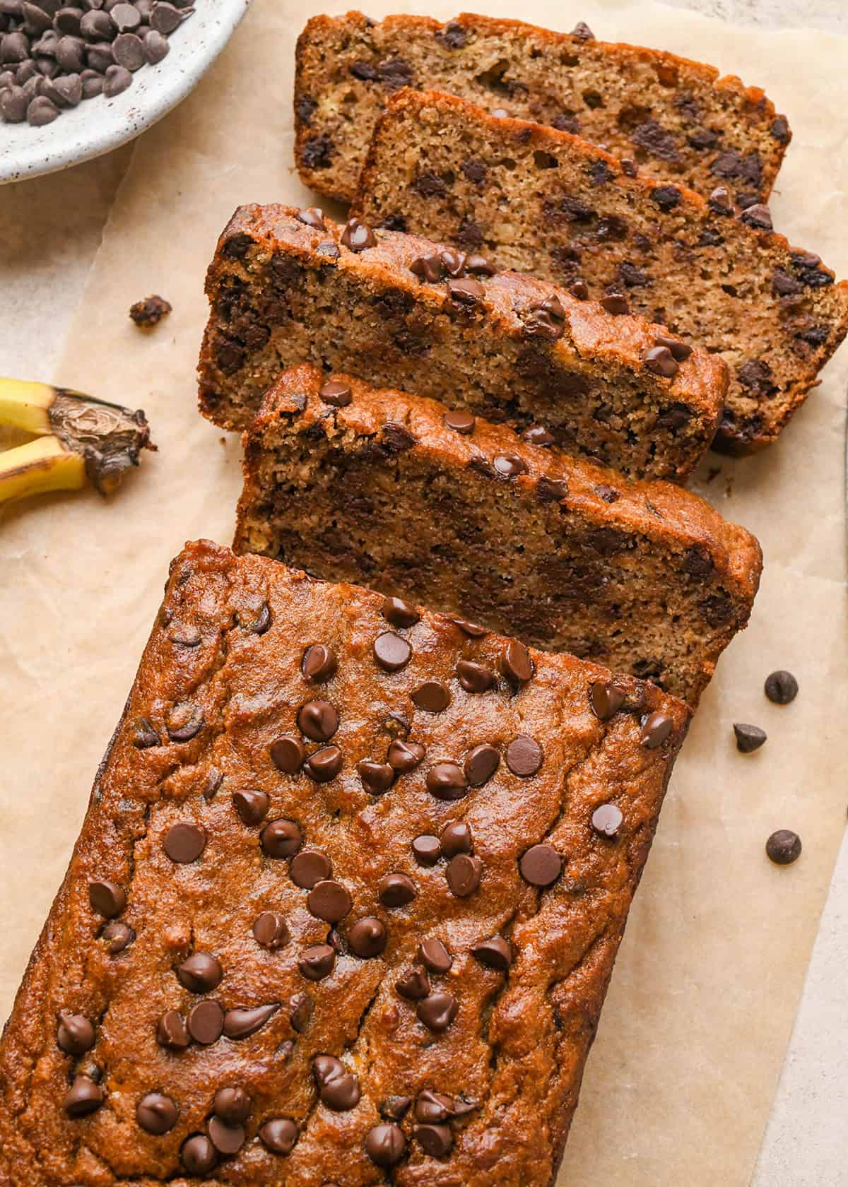 a loaf of paleo banana bread with 4 slices cut out of it 