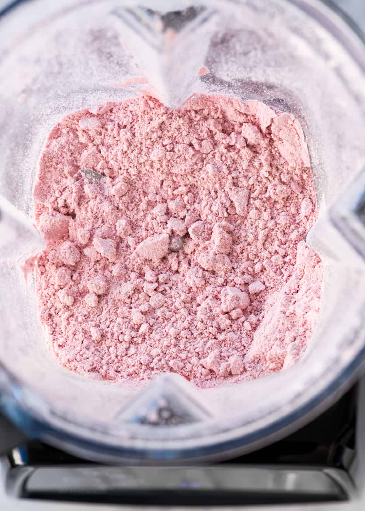 Overhead view of the pink "flour" that is created by blending the dry ingredients in raspberry baked donuts in the vitamix