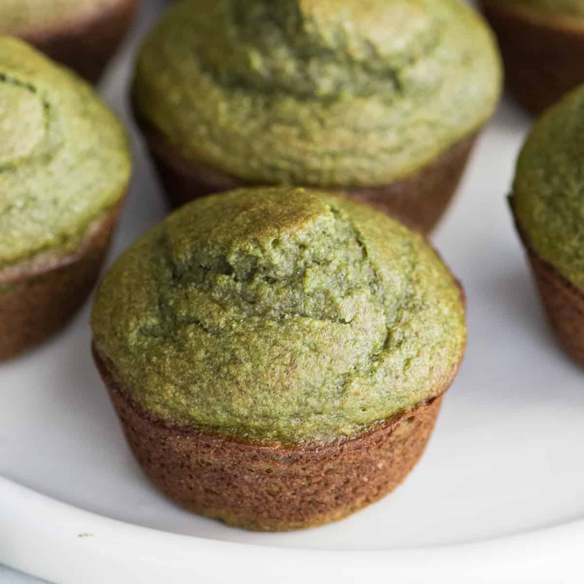 four Banana Spinach Muffins on a white plate 