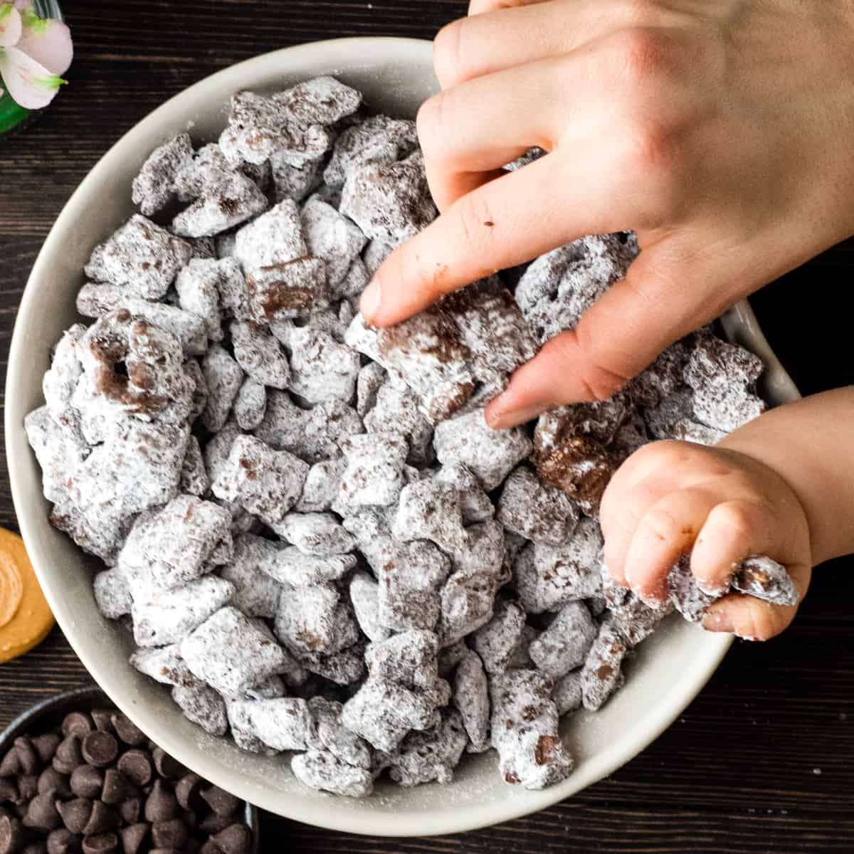 Top 10 Recipes #7 - a bowl of puppy chow with two hands taking pieces out of it