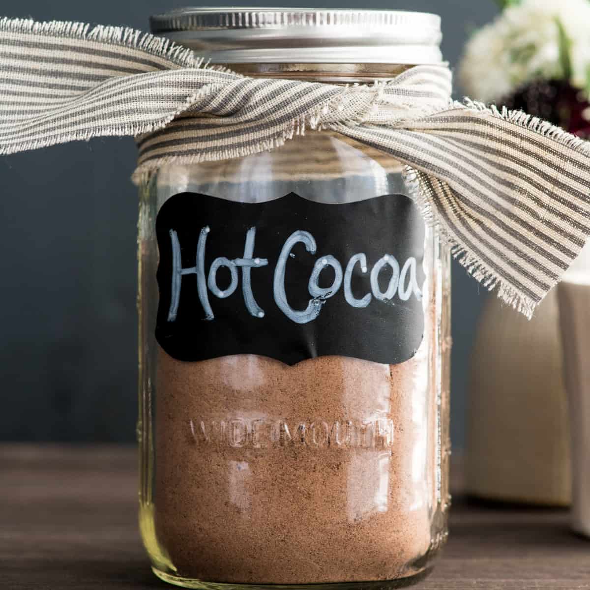 a glass jar labeled "hot cocoa" containing Dairy-Free Hot Chocolate Mix