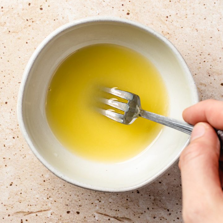 melted butter and olive oil in a white bowl