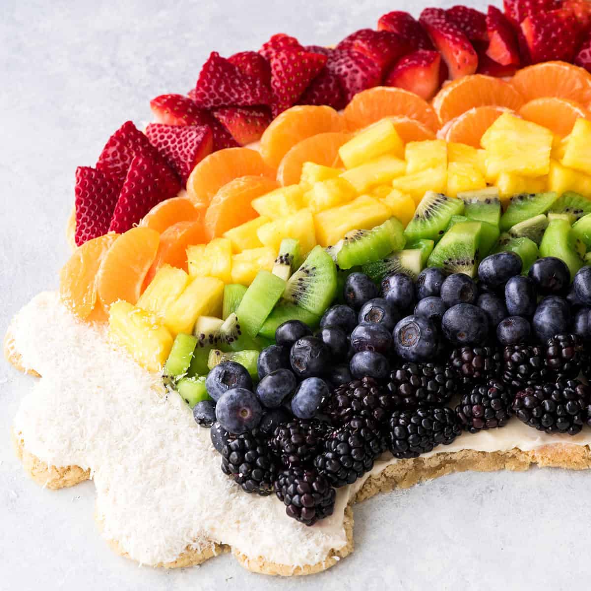 Side view of half of a full rainbow fruit pizza recipe