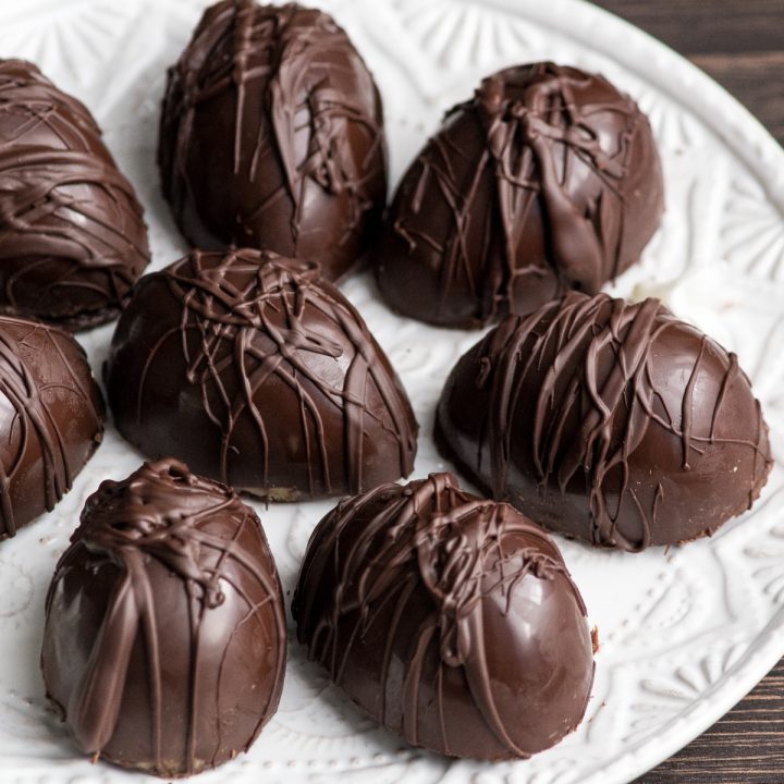 8 dairy-free peanut butter eggs on a white serving plate
