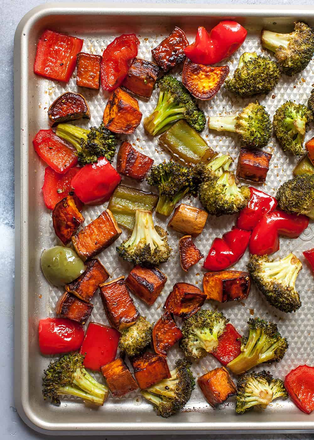 Overhead view of veggies on a baking sheet.