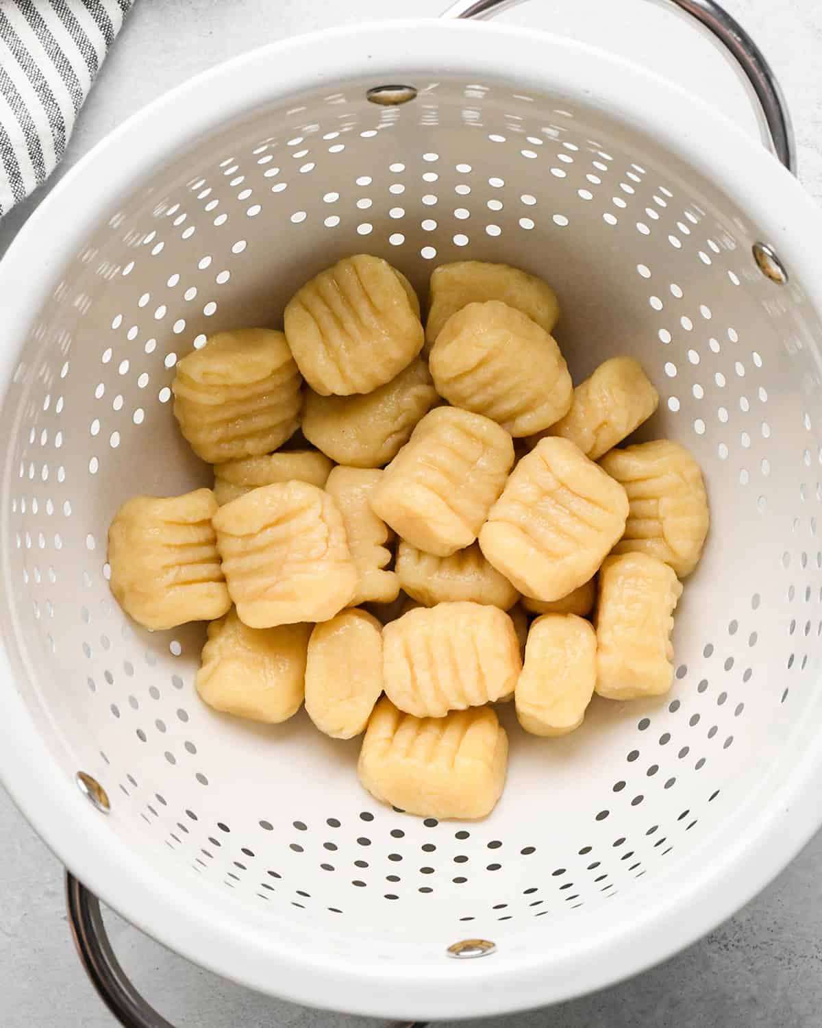 boiled potato gnocchi in a colander draining