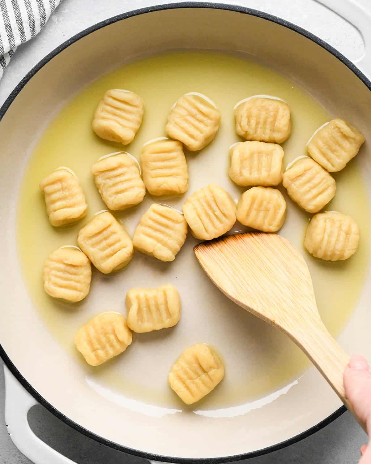 How to Make Potato Gnocchi - gnocchi added to olive oil in a pan