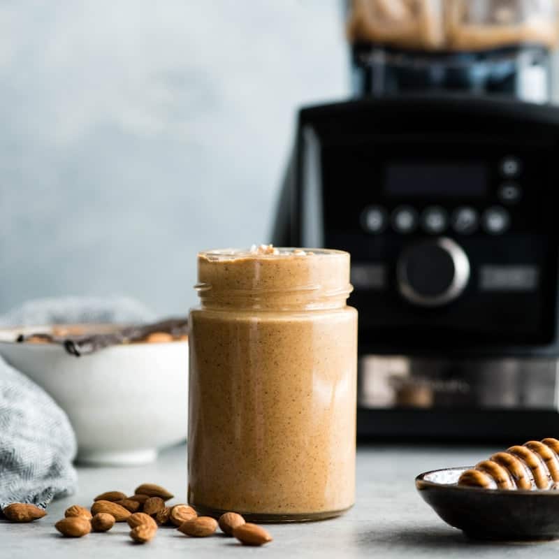 front view of homemade almond butter made in a black stainless Vitamix A3500 blender in this post answering the question Which Vitamix is the Best? (Vitamix Comparison & Buying Guide)