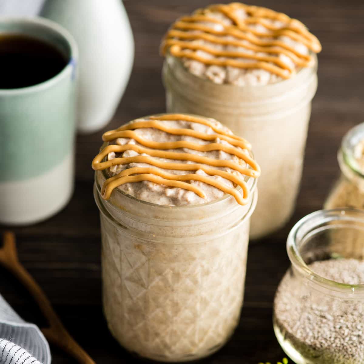 two jars of peanut butter overnight oats with a peanut butter drizzle on top