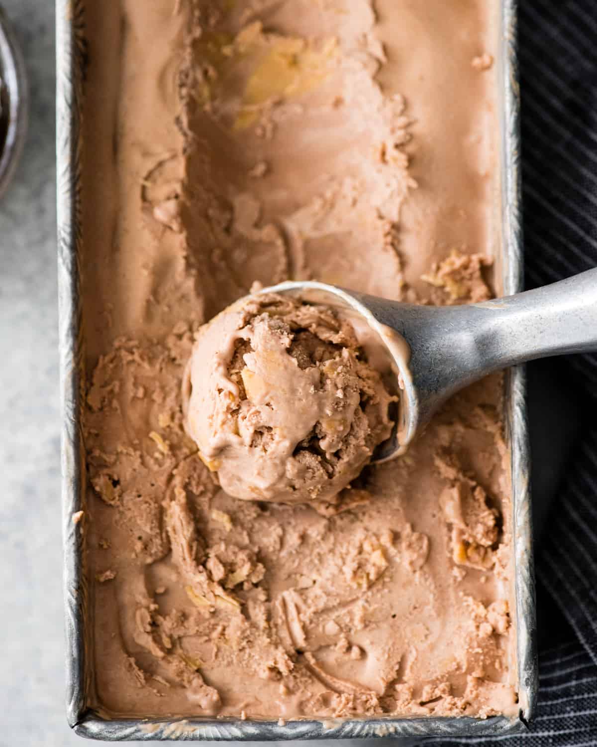 overhead view of dairy-free chocolate peanut butter ice cream being scooped out of a container