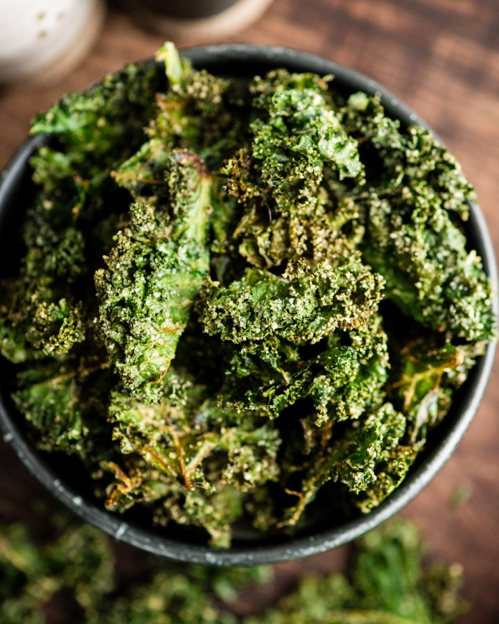overhead view of baked kale chips in a bowl