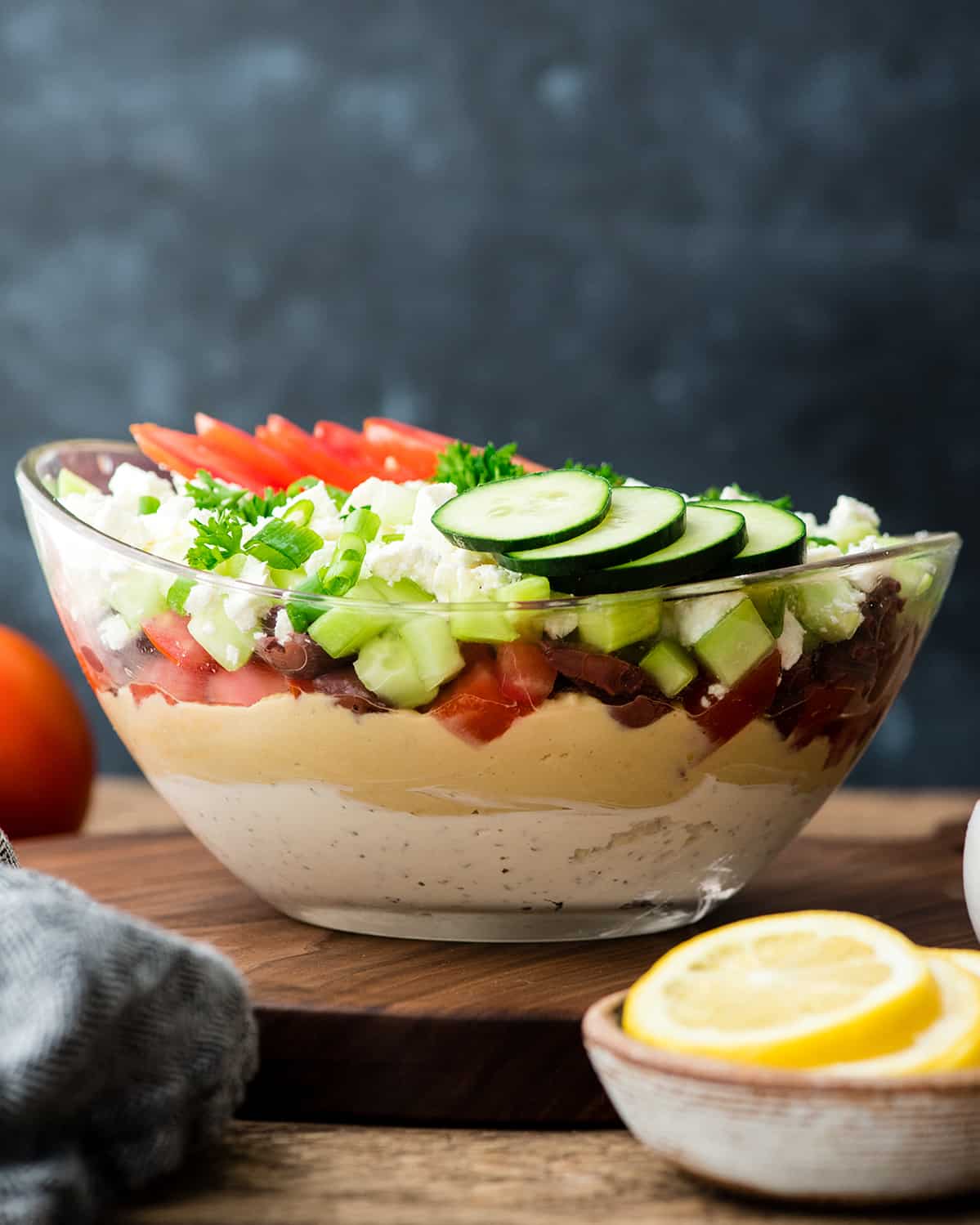 Front view of Layered Greek Dip recipe in a glass bowl 