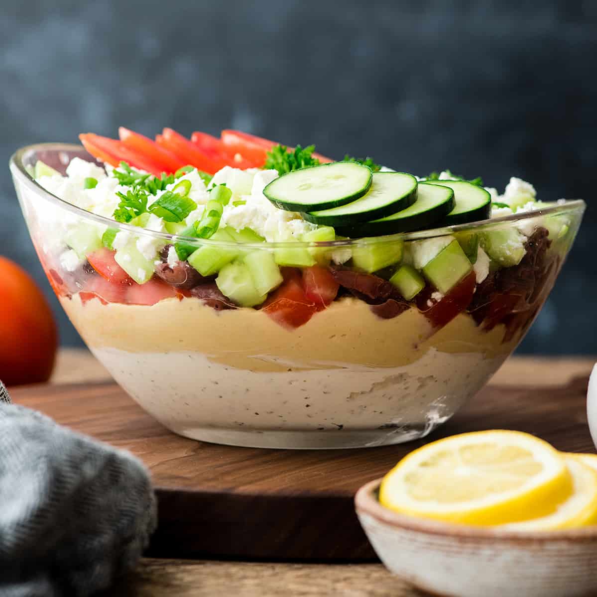 Front view of Layered Greek Dip recipe in a glass bowl 