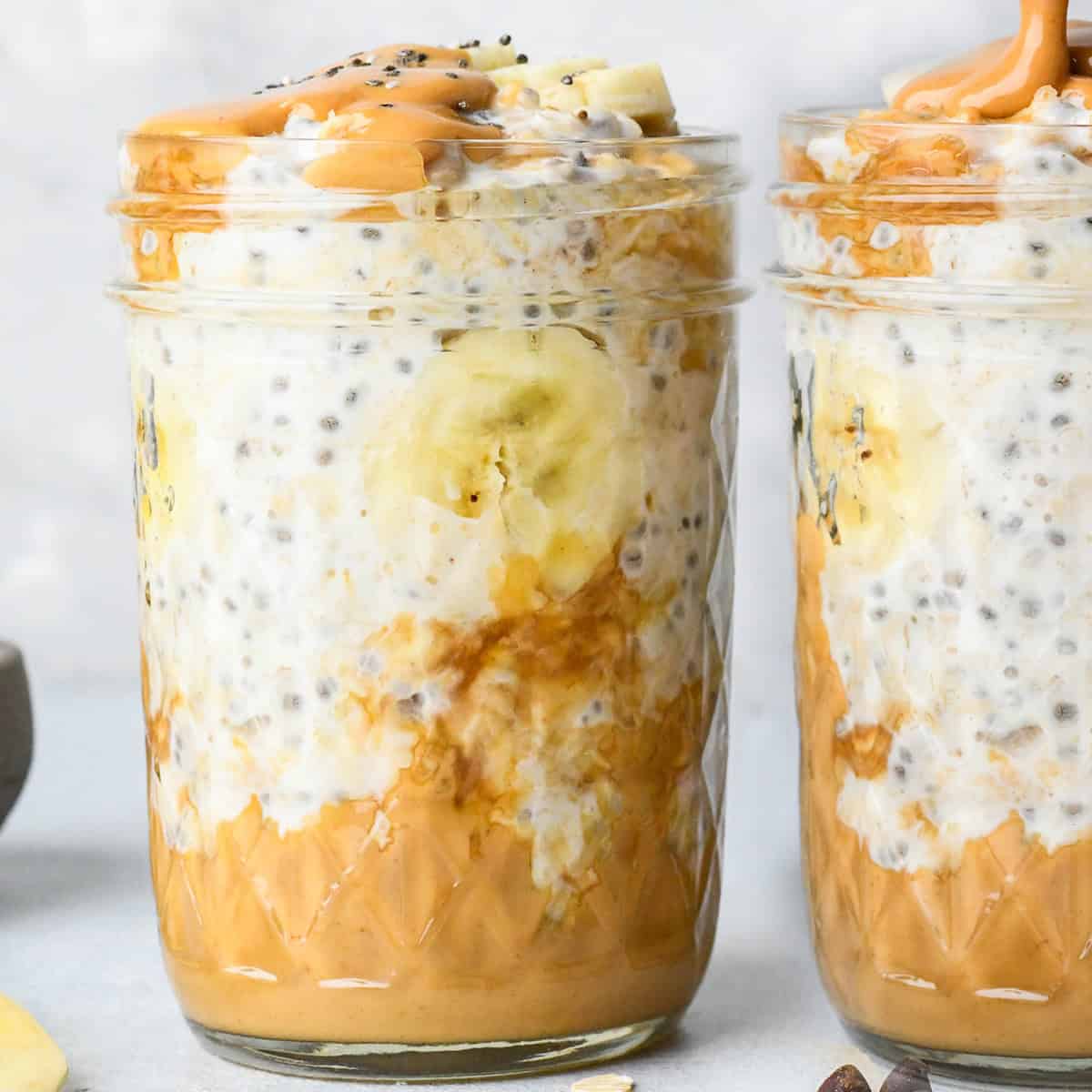 two jars of Peanut Butter Overnight Oats with bananaas