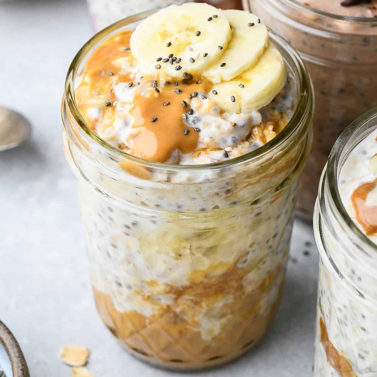 Peanut Butter Overnight Oats in a jar topped with bananas and chia seeds