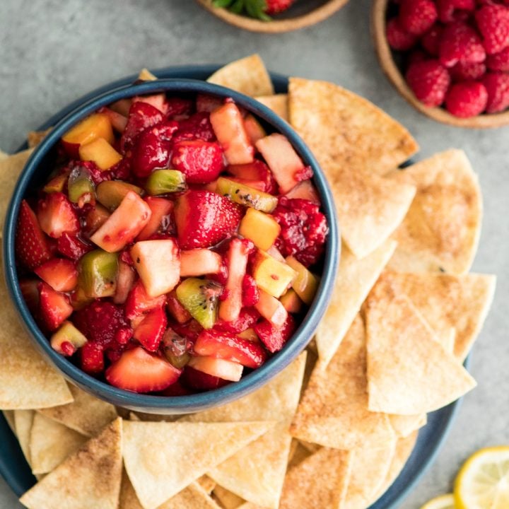 Overhead view of a bowl of fruit salsa with surrounded by cinnamon chips
