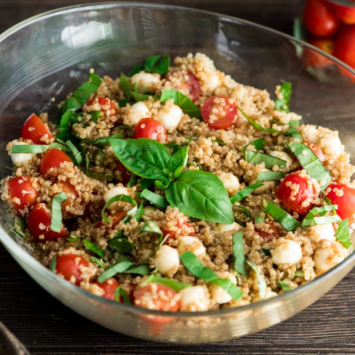 Front view of a glass serving dish filled with Balsamic Caprese Quinoa Salad
