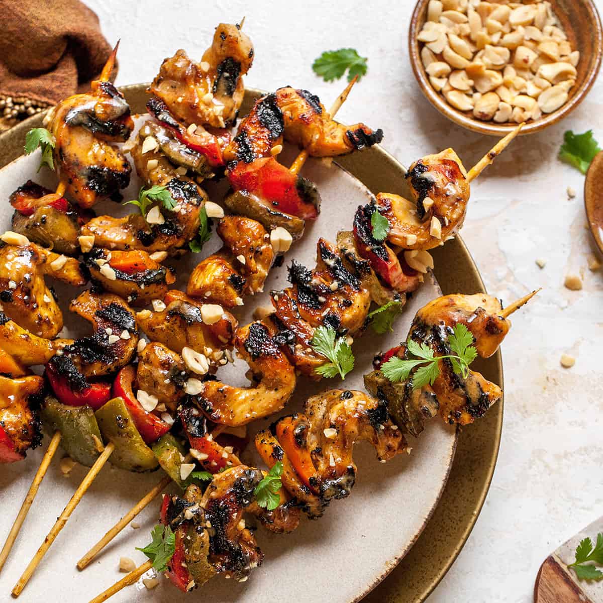 chicken satay skewers on a plate 