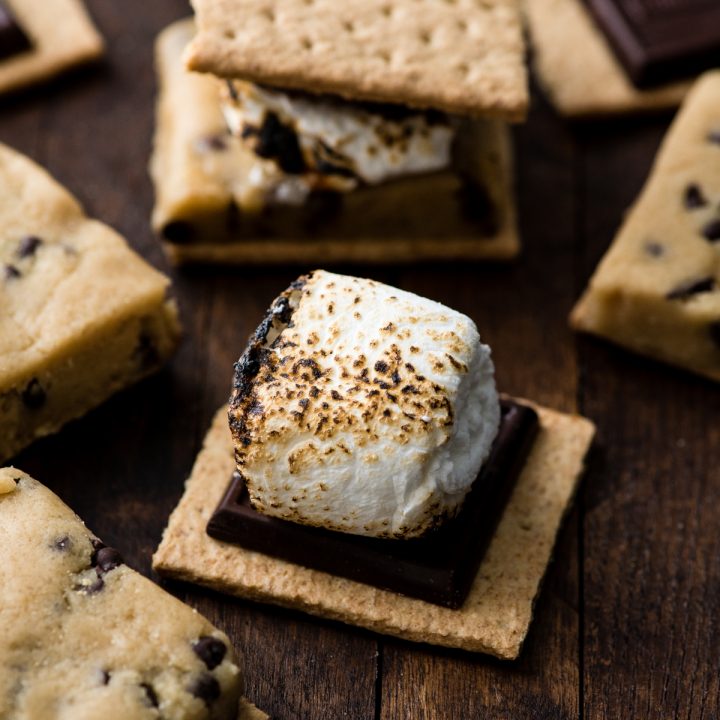 front view of a toasted marshmallow on top of a graham cracker being ready to be made into this Cookie Dough s'mores recipe