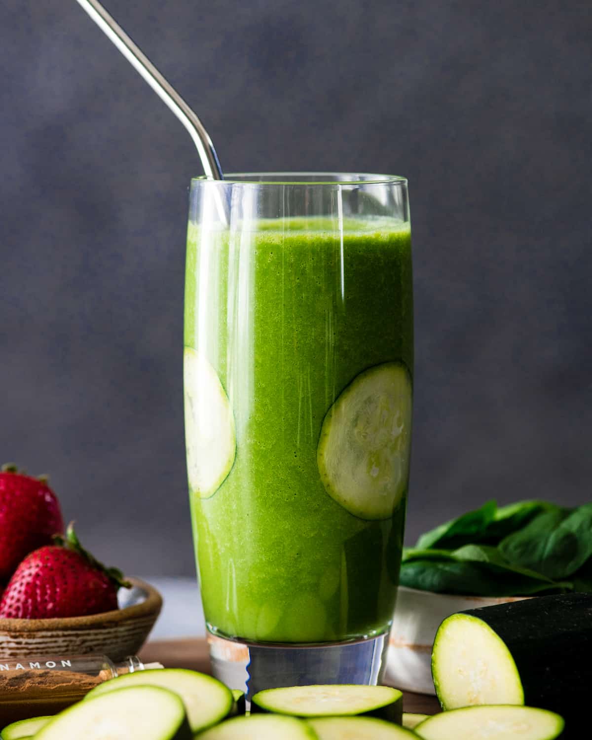 Up close front view of a Zucchini Smoothie in a glass with a straw