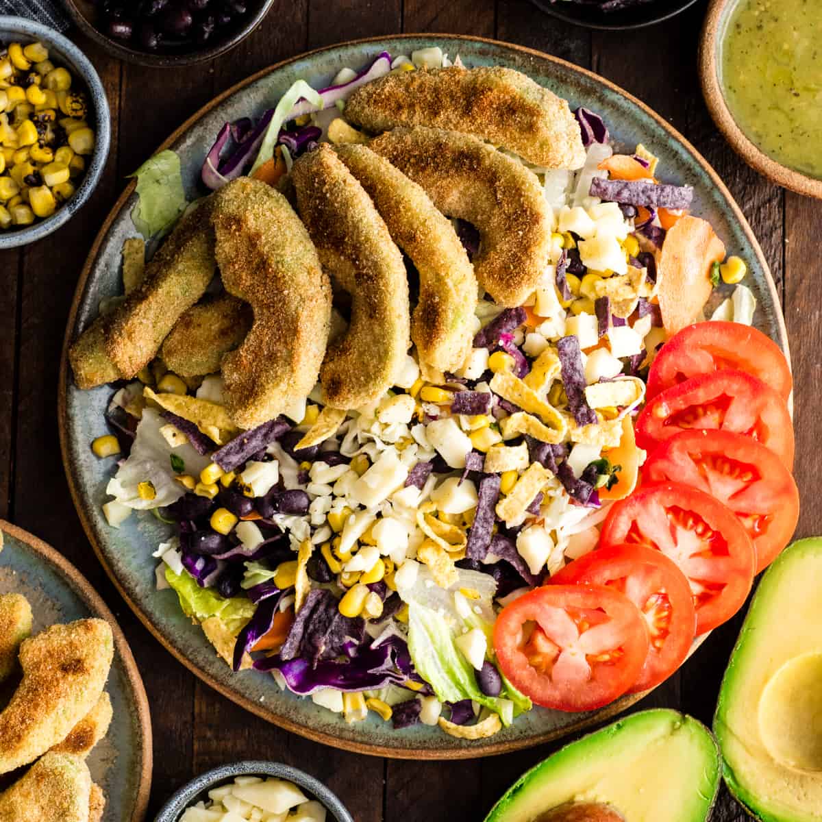 Baked Avocado Fries on top of a salad. 