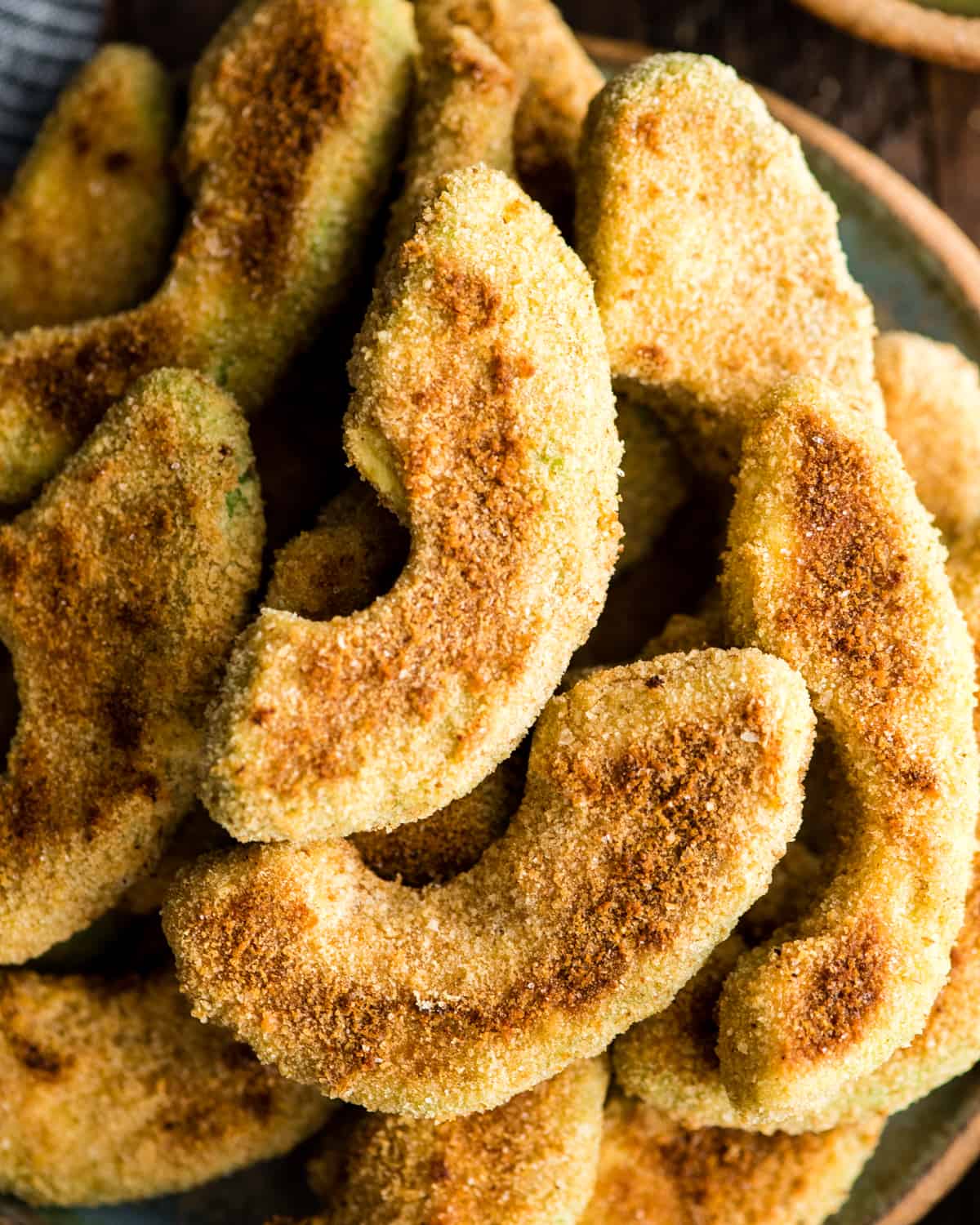 up close overhead view of Baked Avocado Fries recipe after they have been removed from the oven and arranged on a plate