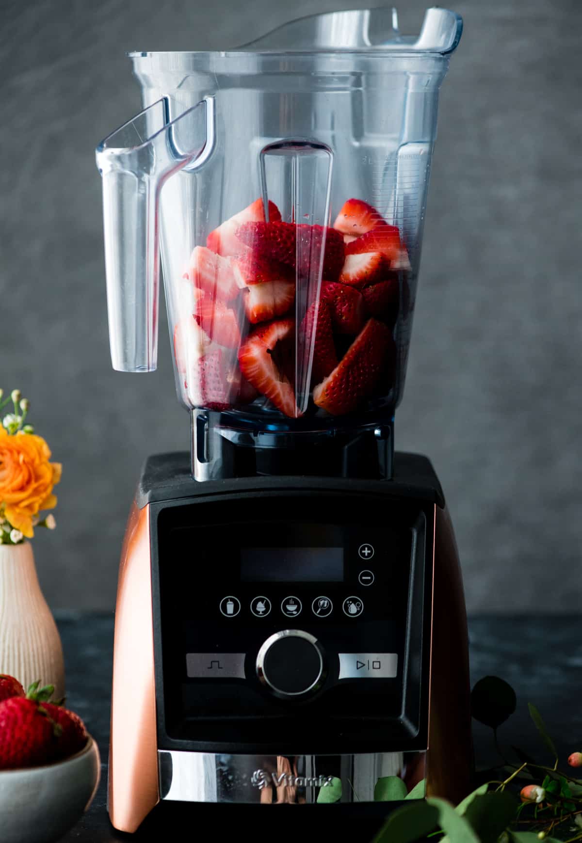 Front view of strawberries in a vitamix blender ready to be made into this Strawberry Sauce recipe