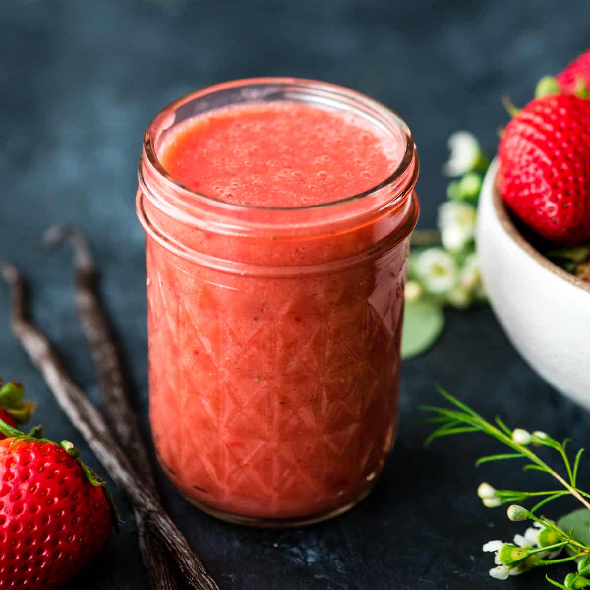 Front view of a glass jar full of Strawberry Sauce recipe