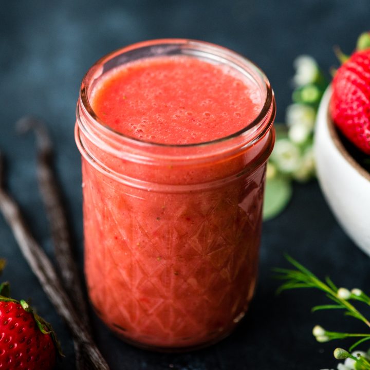 Front view of a glass jar full of Strawberry Sauce recipe