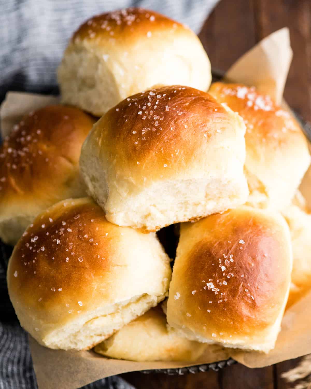 front view of a basket with 6 Dinner Rolls stacked on top of each other 