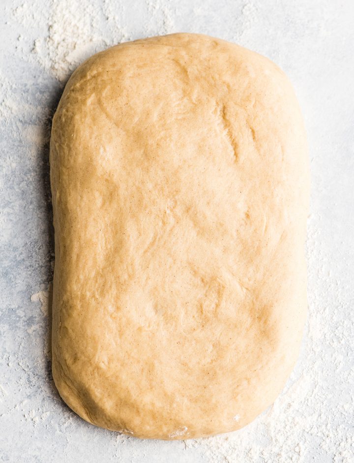 overhead photo of cinnamon roll dough formed into a rectangle
