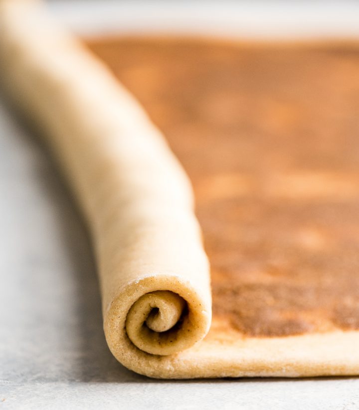 front photo showing how to roll cinnamon roll dough