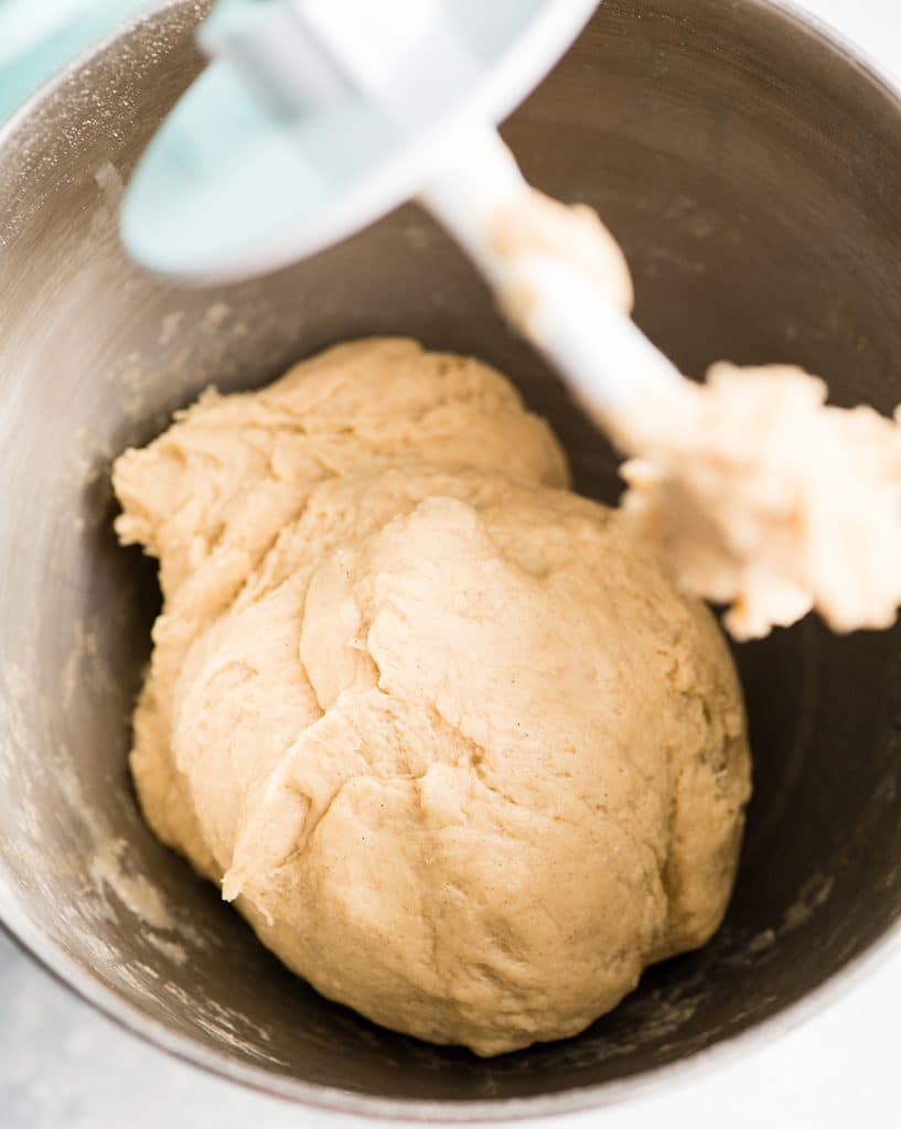 overhead view of the dough for this Best Cinnamon Rolls Recipe (Better than Cinnabon) in the bowl of the standing mixer after it has been kneaded