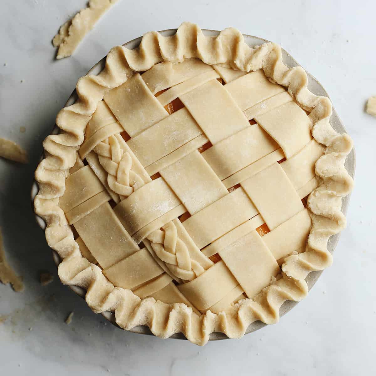 overhead photo of a Butter Pie Crust in a lattice pattern before baking
