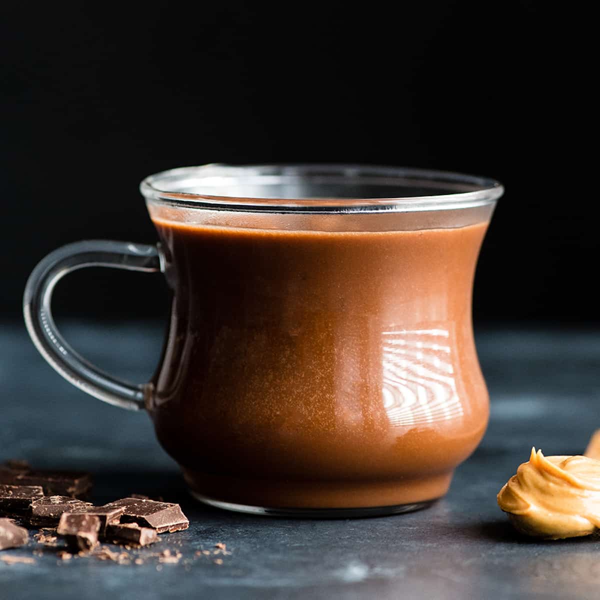 a glass mug filled with Peanut Butter Hot Chocolate
