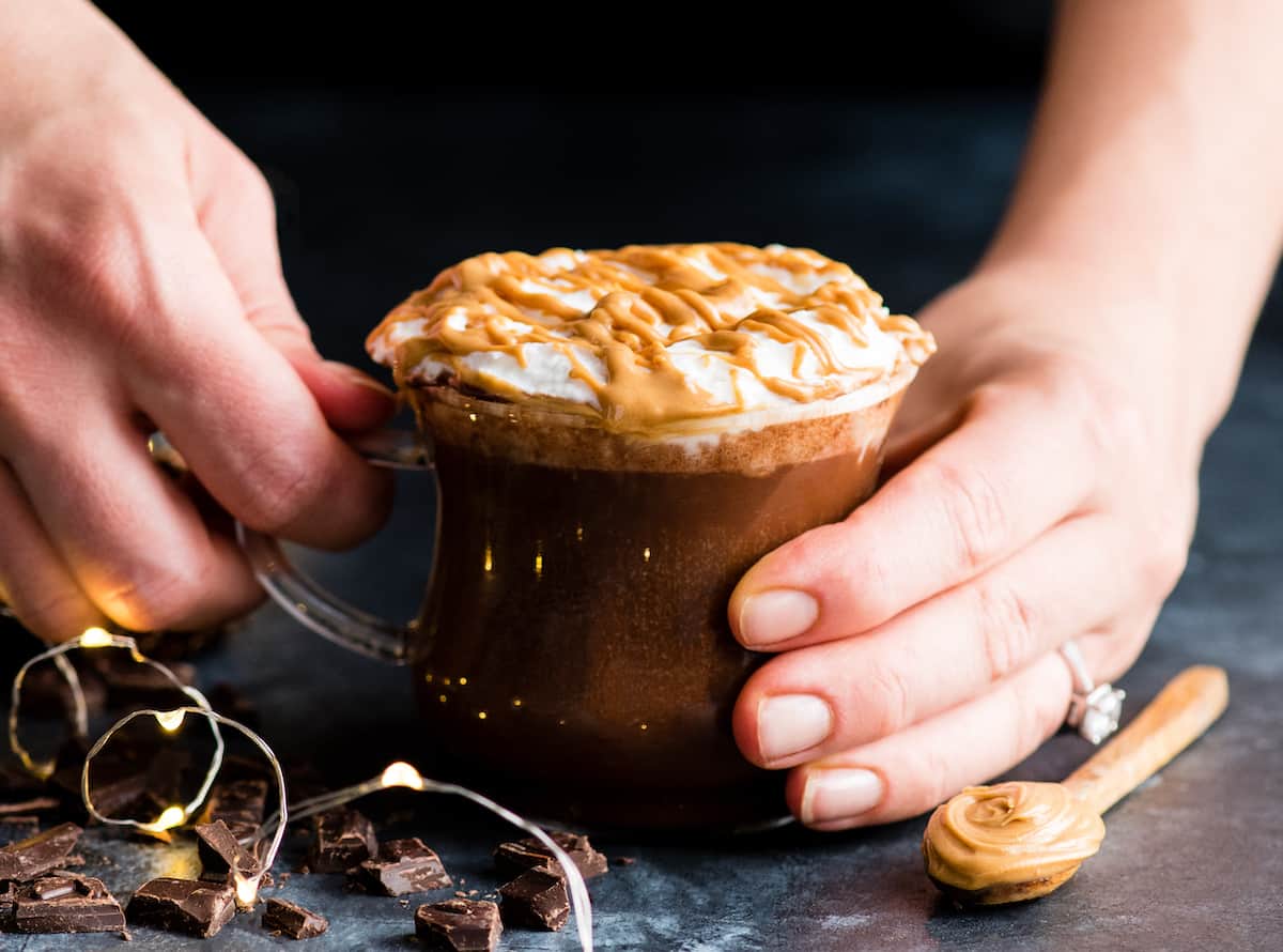 hands holding a mug of Peanut Butter Hot Chocolate