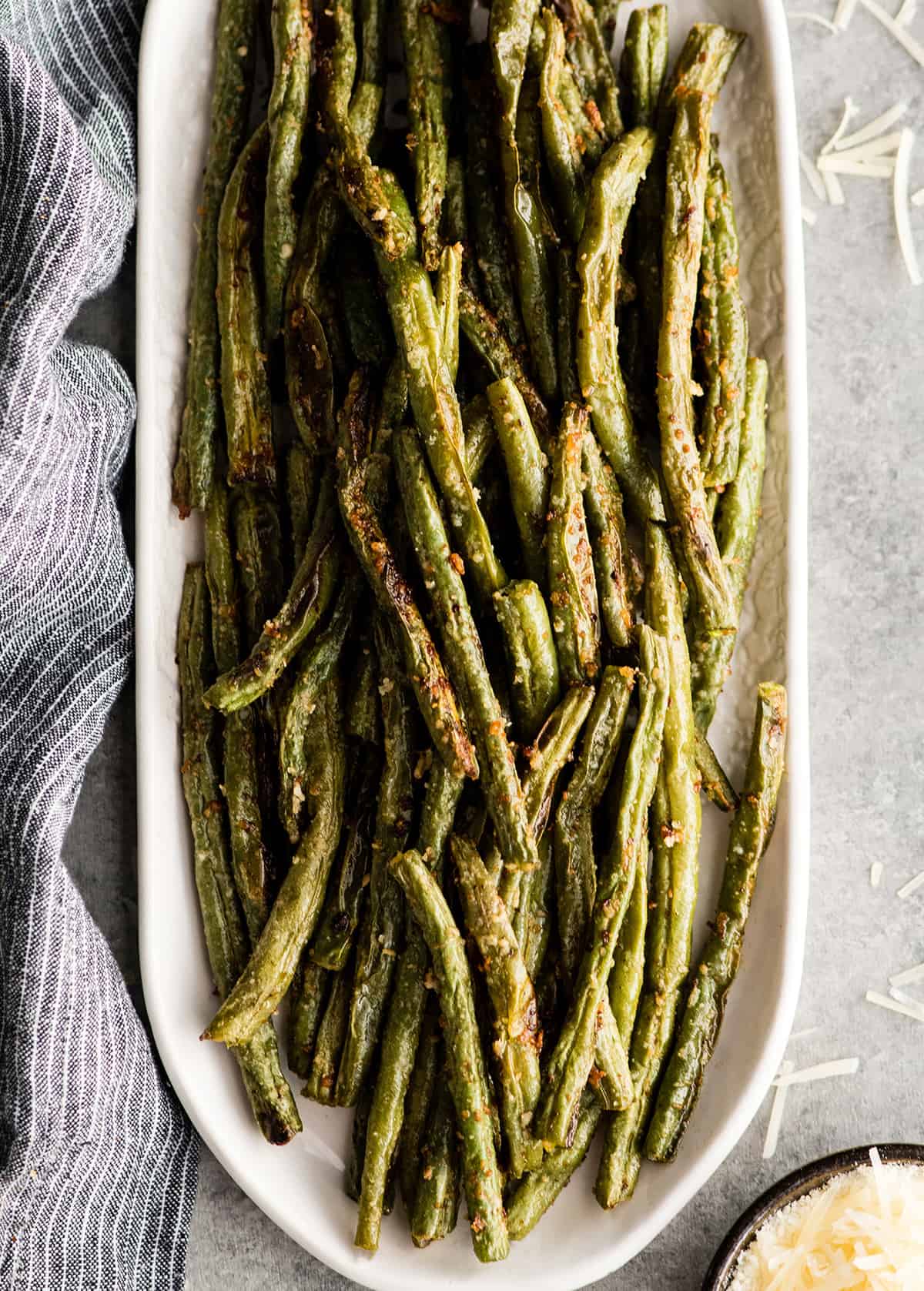 Overhead view of Roasted Parmesan Green Beans on an oval serving dish