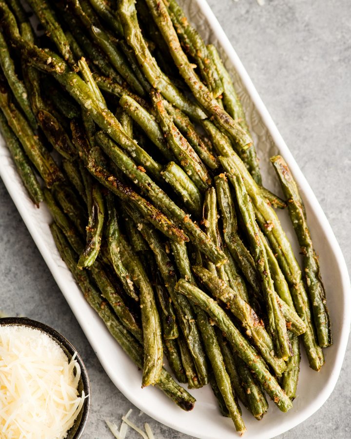 Overhead view of Roasted Parmesan Green Beans on an oval serving dish