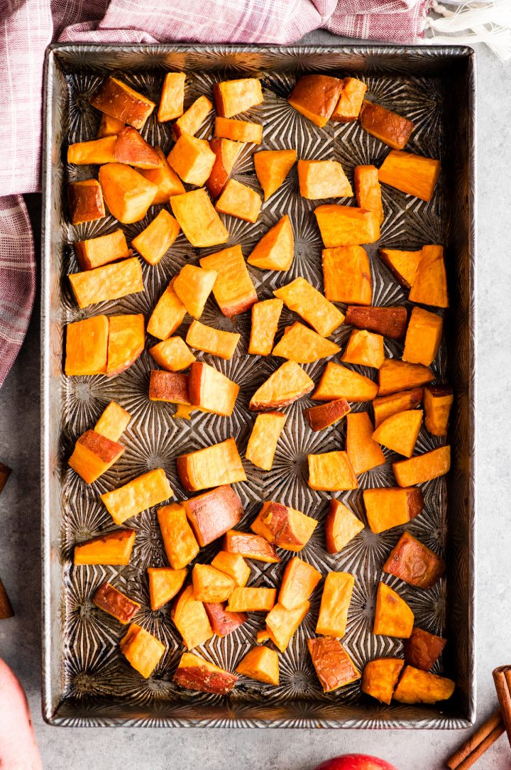 overhead view of a pan of sweet potatoes roasted alone which is the first step in making this Cinnamon Roasted Sweet Potatoes and Apples recipe