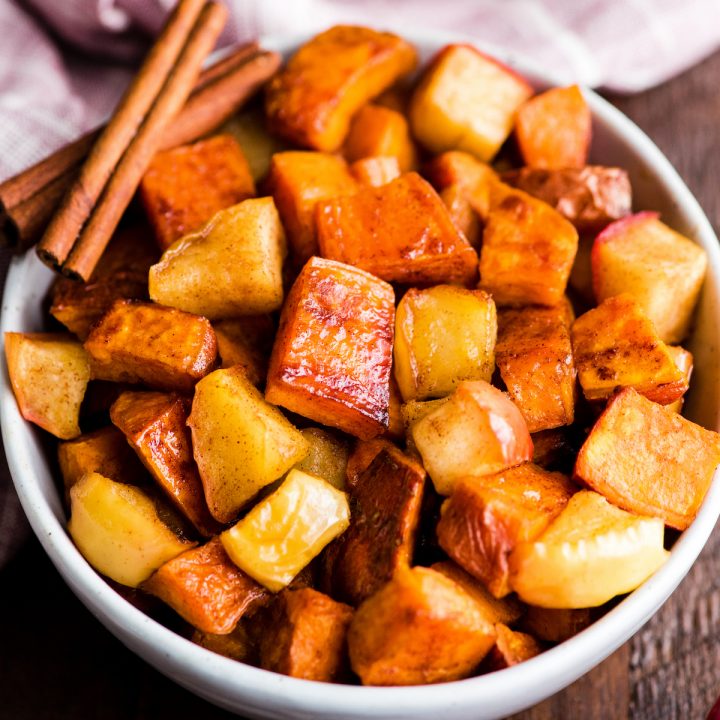up close front view of a bowl of cinnamon roasted sweet potatoes and apples ready to be served