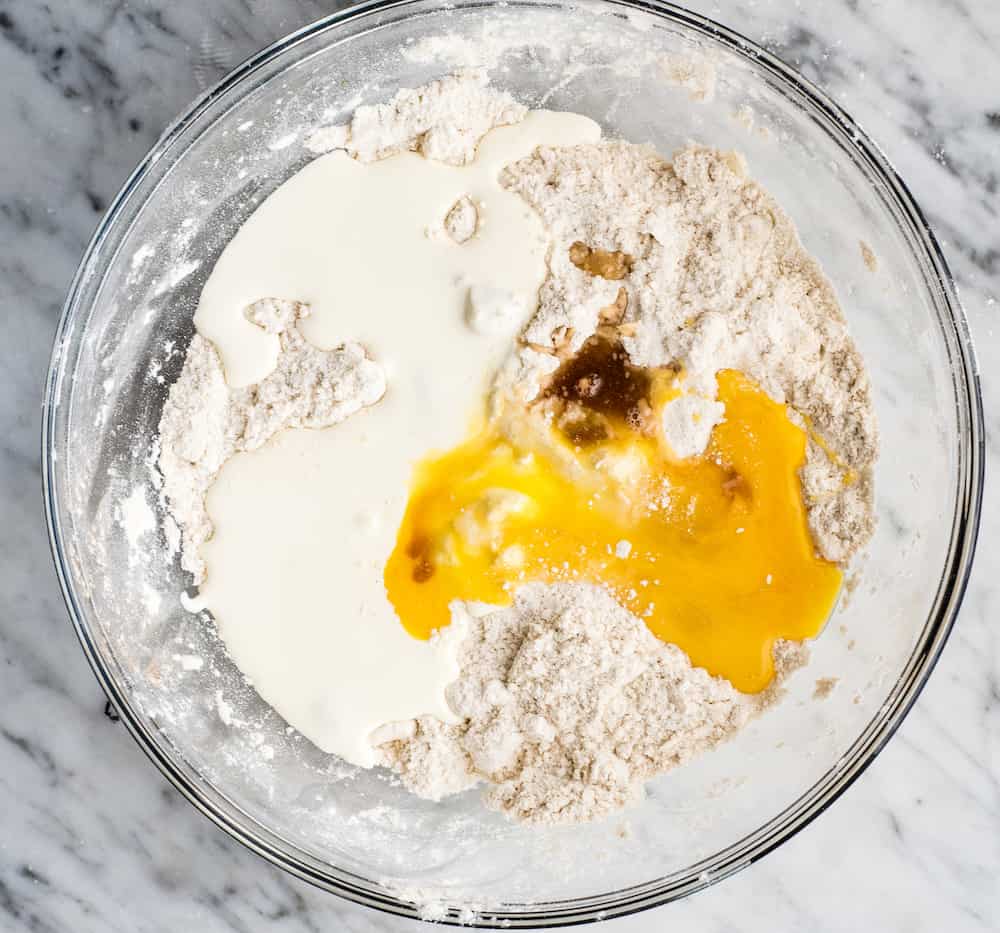 overhead view of a bowl with the wet ingredients added to the dry in the making of these Cinnamon Scones (with Cinnamon Chips)