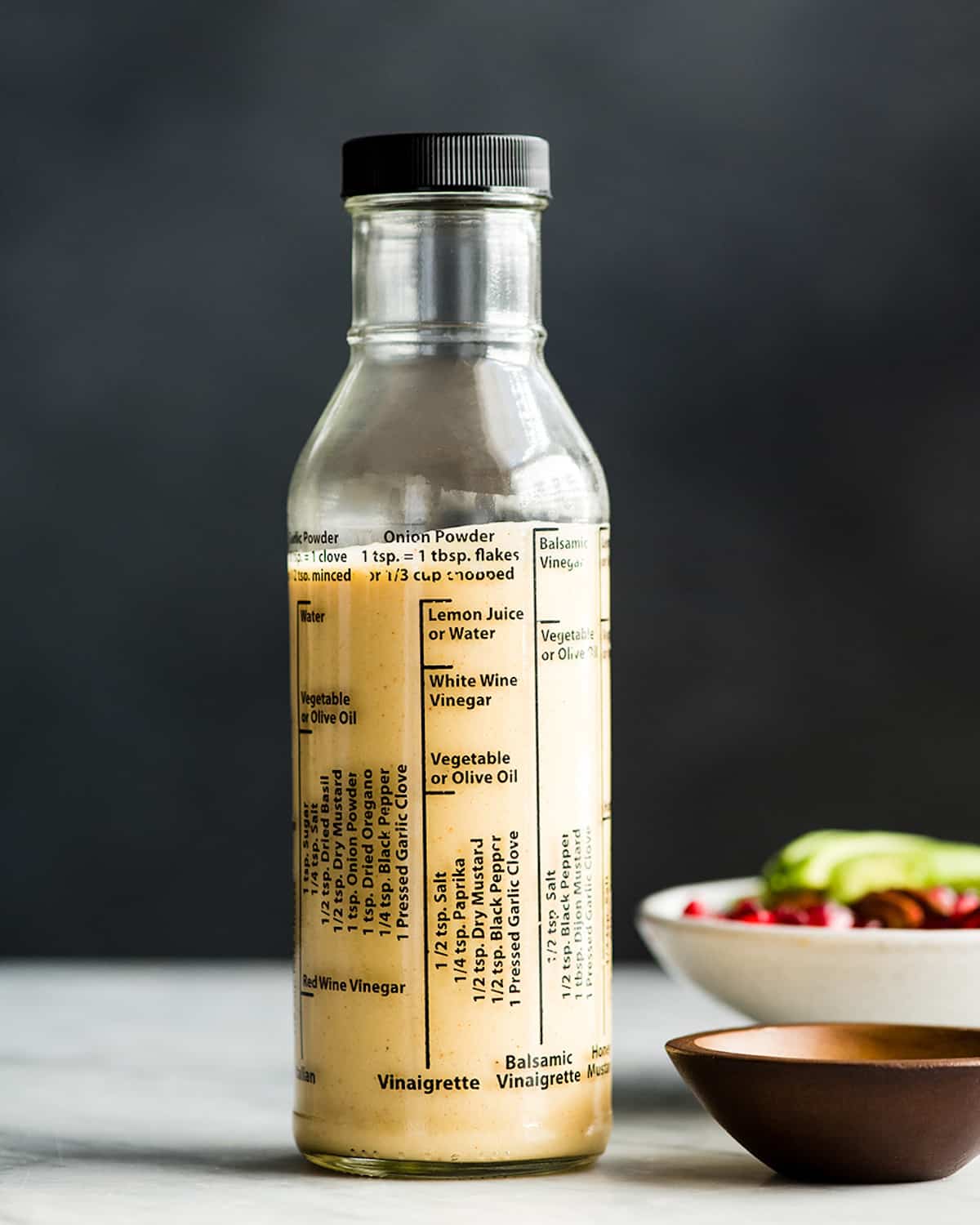 front view of a glass bottle filled with Apple Cider Vinaigrette dressing