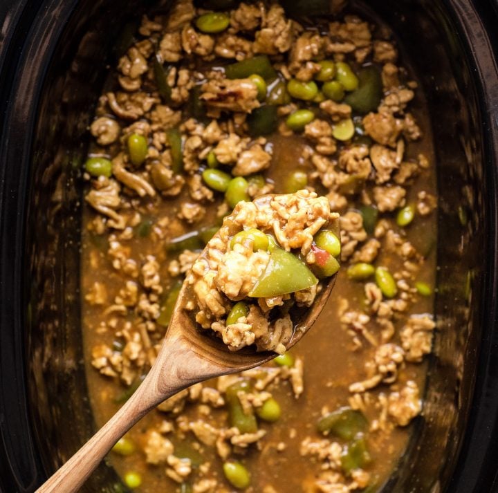 Overhead view of a spoon taking a scoop of Thai Slow-Cooker Ground Turkey recipe out of the crockpot 
