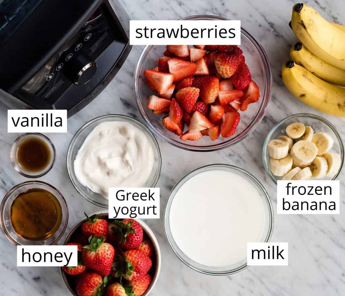 overhead photo of the labeled ingredients in this strawberry banana smoothie recipe