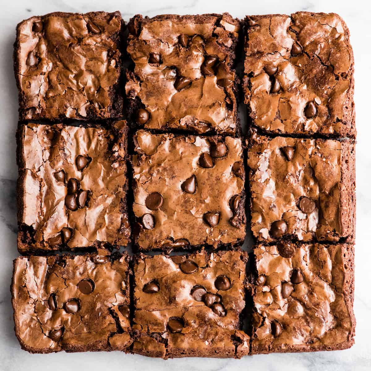 Overhead view of nine Paleo Flourless Brownies cut into squares arranged in 3 rows of 3