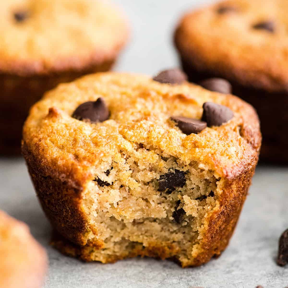 a Gluten Free Chocolate Chip Muffin with a bite taken out of it