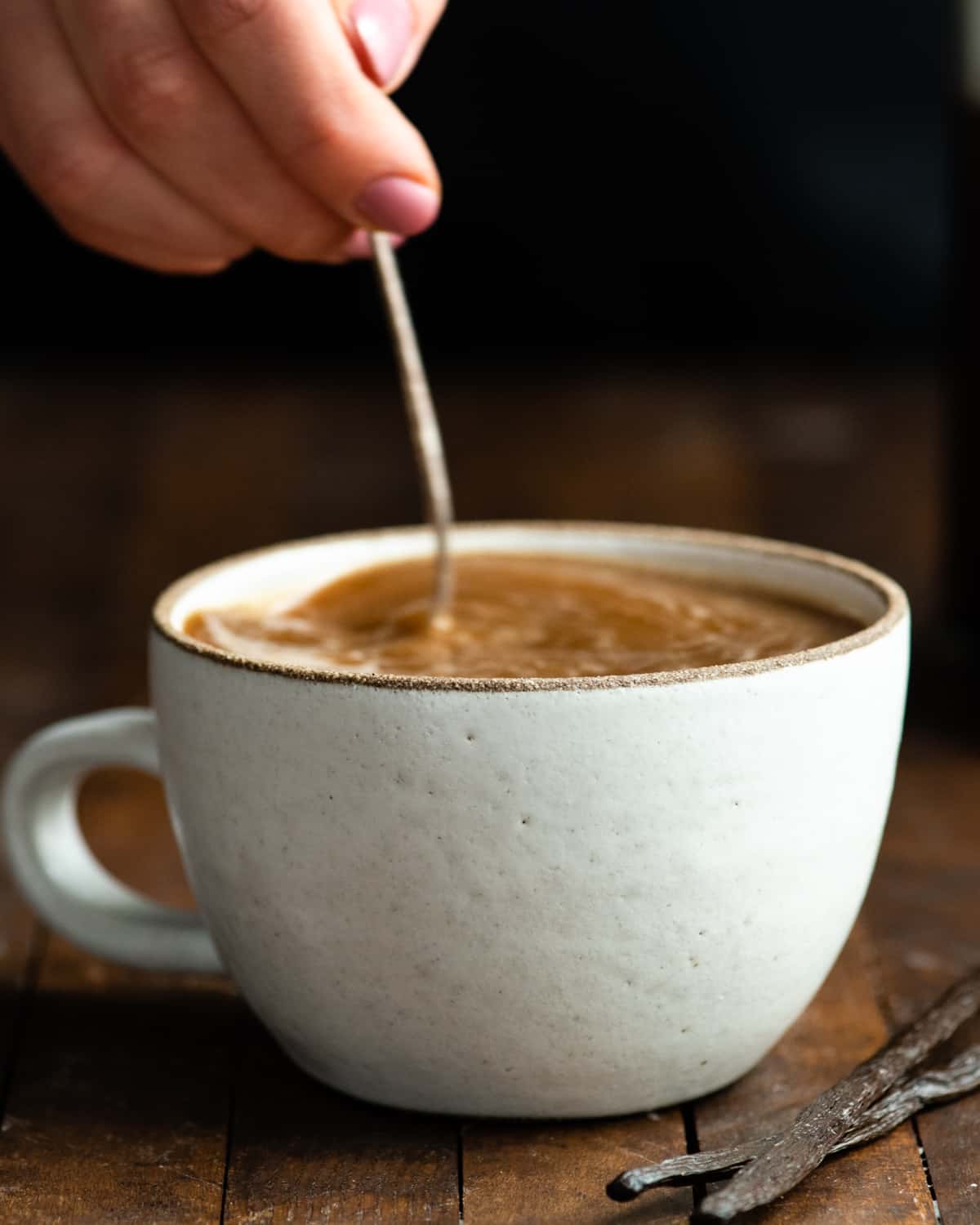healthy coffee creamer being stirred into a mug of coffee